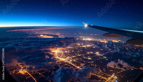 Breathtaking aerial perspective from an airplane window, capturing the dazzling city lights illuminating the night sky above a blanket of soft clouds during a serene flight journey