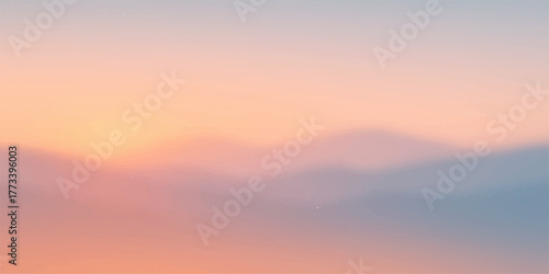 Orange and red light from a majestic sunset or tranquil sunrise illuminates a dramatic mountain landscape with wispy clouds in the sky