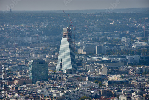 Panoramic view of Paris from the Montparnasse Tower with the Tour Triangle under construction standing out against the traditional cityscape