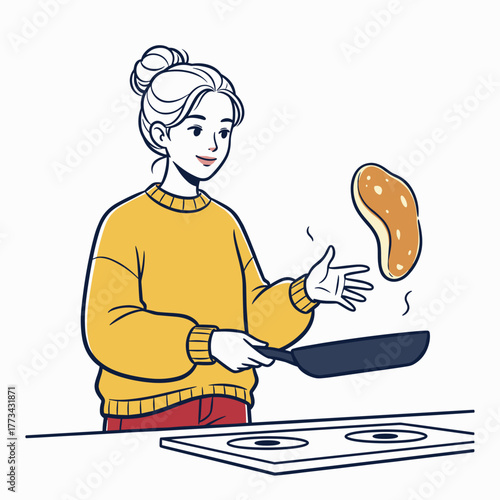 Young woman flipping pancake in skillet while smiling in kitchen  