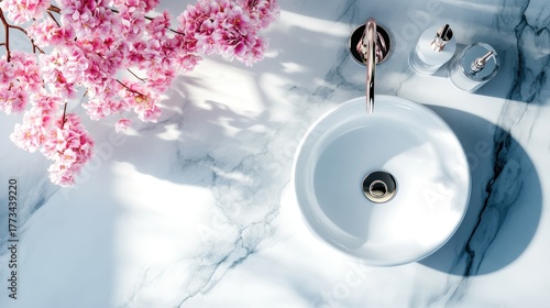 Elegant bathroom sink with cherry blossoms and marble countertop.