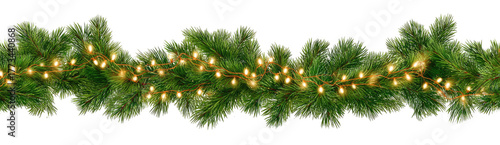 Green pine garland with warm glowing lights on black