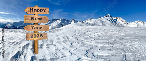 happy new year 2026 written on a wooden directional sign with a panoramic vie...