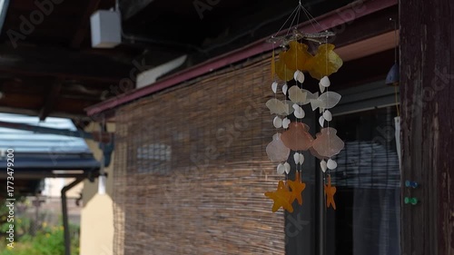 軒下で風に揺れるシェルウィンドチャイム