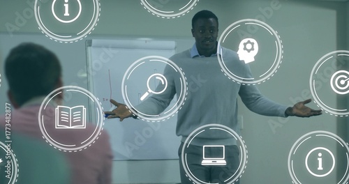 Papier peint Presenting trainer in sweater and collared shirt gesturing in training room, wit