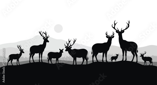 Silhouette of deer family standing on a hill with mountains and sun in the background black and white
