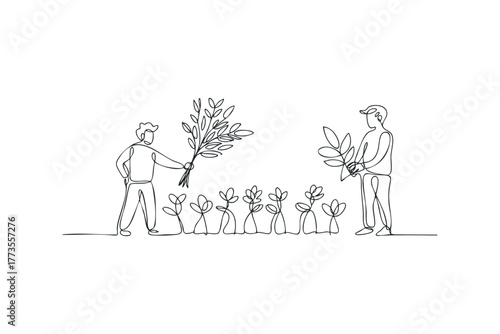 Two gardeners tending to plants and flowers in a line