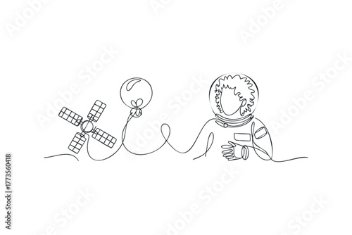 Astronaut holds balloon tethered to satellite