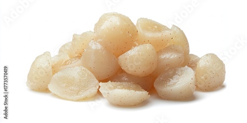 A pile of fresh, peeled scallops rests on a white surface. The scallops are uniformly sized and have a slightly translucent, pale beige color