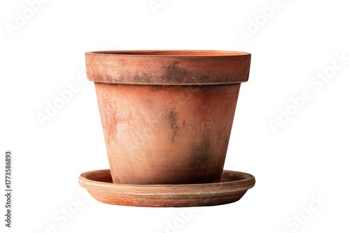 A rustic terracotta pot with a matching saucer sits against a black background