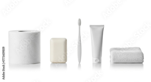 Bathroom essentials still life photo: toilet paper, soap, toothbrush, towel