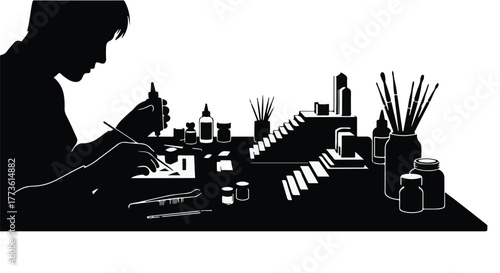 Focused individual meticulously assembling a detailed miniature model with precision tools and paints.