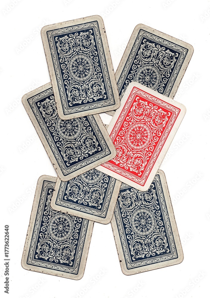 Fototapeta premium A hand of vintage playing card backs with one card in a different colour.