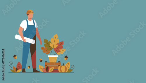 Draftsman in hard hat holding blueprints by fall harvest decor