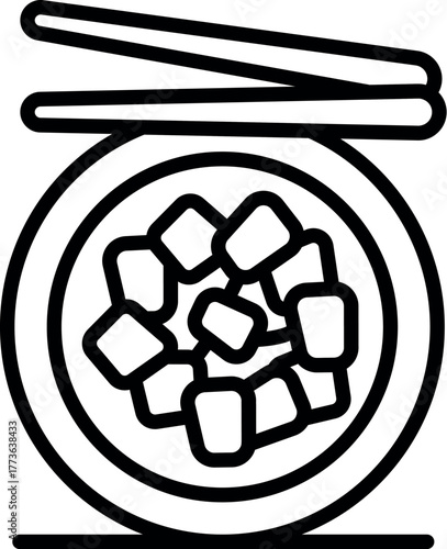 Chopsticks poised above a bowl of miso soup containing chunks of tofu, ready for a delicious meal