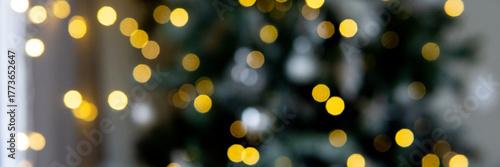 Blurred Christmas tree lights with golden bokeh. Festive holiday background. New Year celebration and winter season decoration.