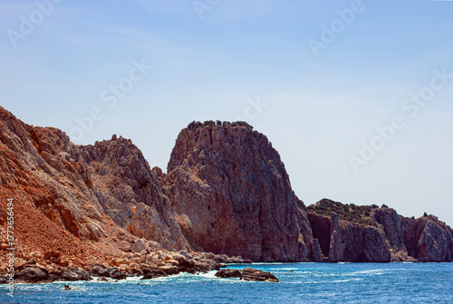 The rocky coastline of Suluada Island in the Mediterranean Sea, off the coast of Turkey. With its white sandy shores and turquoise waters, it is often compared to the Maldives.