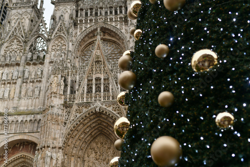 A big cathedral in Rouen with a decorated Christmas tree