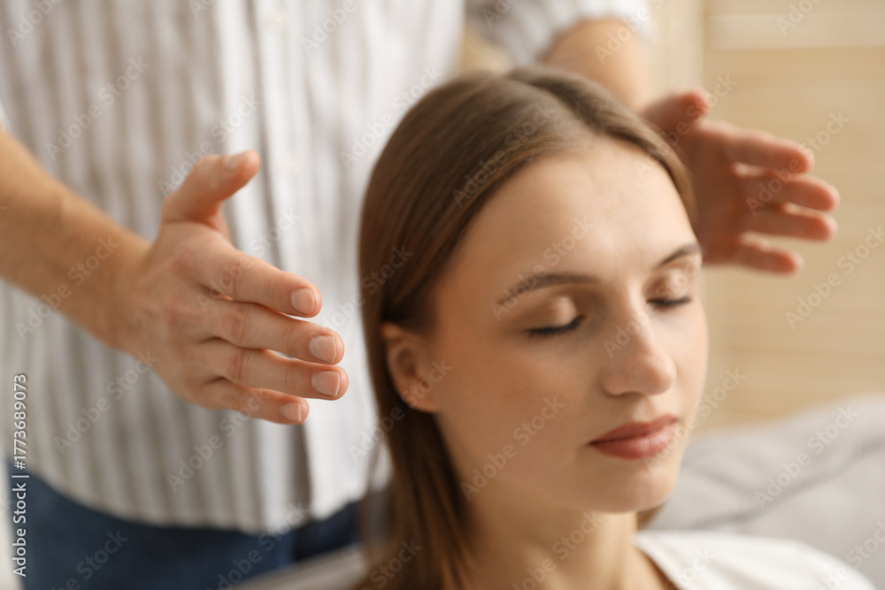 Fototapeta premium Reiki master healing patient's aura during therapy indoors, closeup