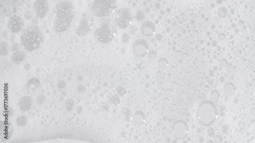 Bubbles of white soap foam. Moving Soap foam popping bubble on a white backdrop. Soap sud macro structure. Clean, cleaning concept, laundry, shower. . High quality 4k footage