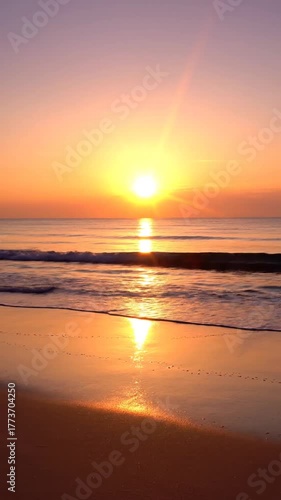 Ocean sunset vibrant colors and calm water at dusk with golden sunlight