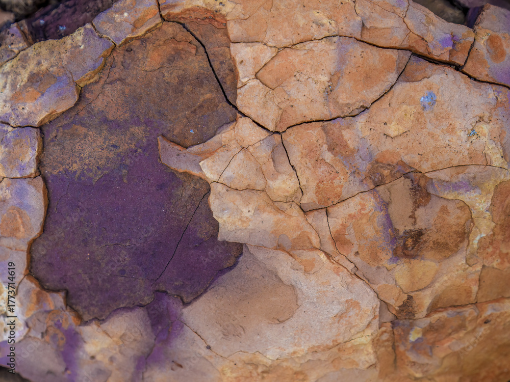 Fototapeta premium The texture and colors of a rock in the desert, macrophotography captured in La Candelaria desert, in the eastern Andean mountains of central Colombia, near the town of Raquira.