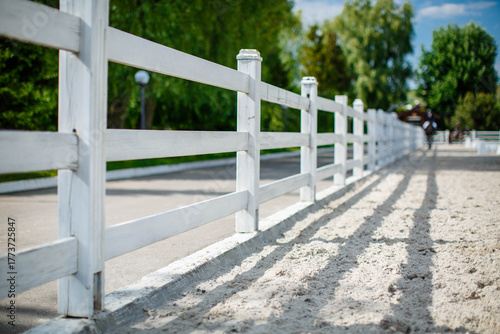 A typical American horse fence in the countryside. White fence.