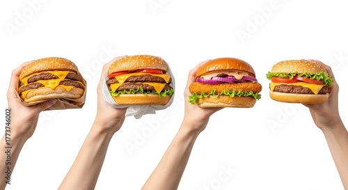 Four delicious burgers held by hands isolated on a transparent background