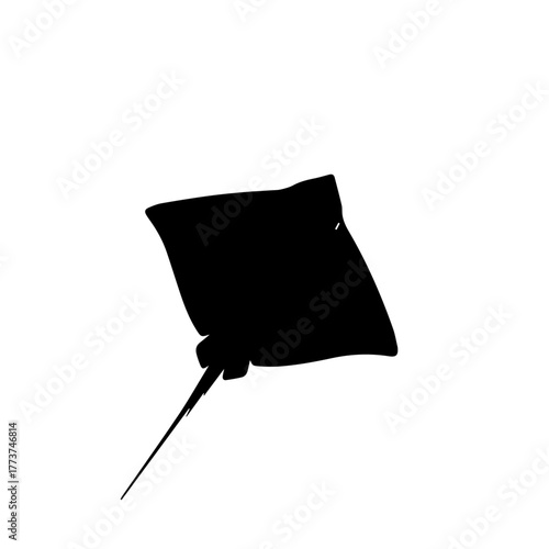 Silhouette of a stingray swimming in the ocean.