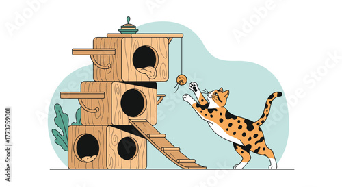 A playful calico cat jumps to bat at a dangling ball near a multi-level wooden cat tree.
