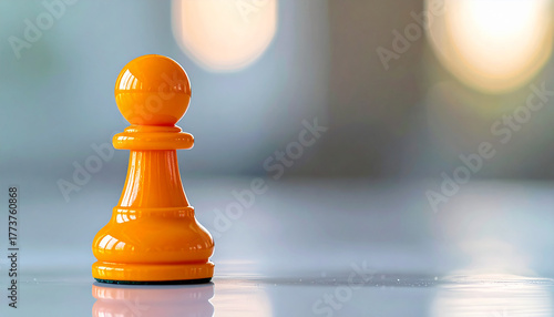 Glossy orange chess pawn, soft blurred background, concept of distinctiveness and individuality.