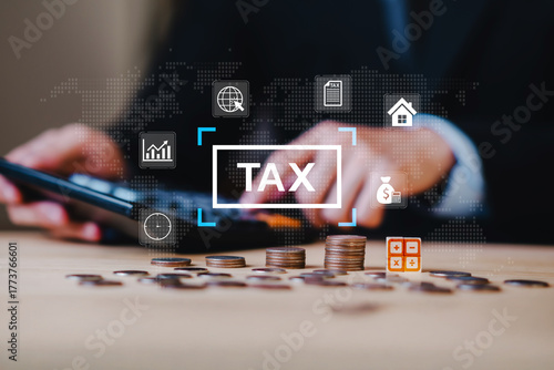 Close up of hands using calculator with stacked coins and tax icon, representing financial strategy, income planning, tax saving, personal finance, money management, and accounting.