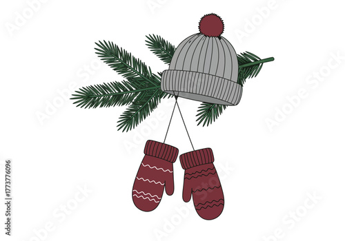 A gray knitted winter hat and red mittens hanging on a green fir tree branch.