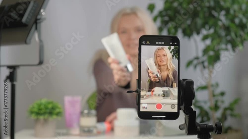 Face, makeup influencer or vlog with girl, spray or advice with content creator, promotion for cosmetics product or live streaming. Portrait, person or woman with item for skincare or record tutorial