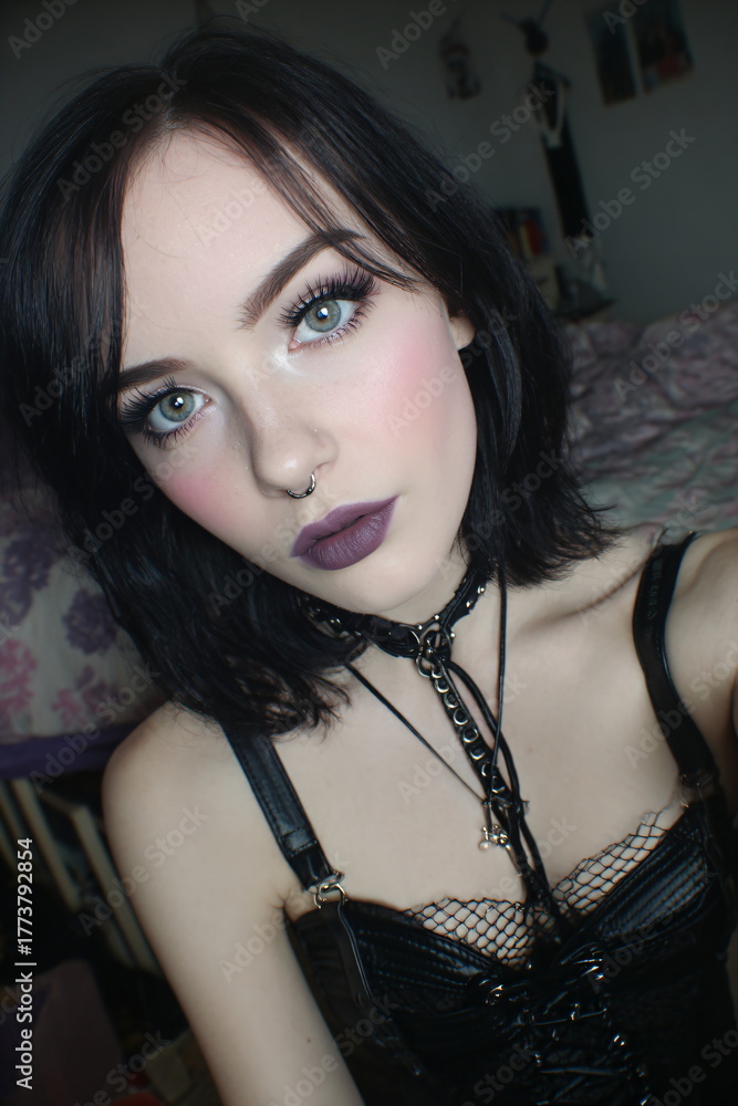 Fototapeta premium Young Gothic Emo Woman in Black Leather Corset with Dramatic Makeup