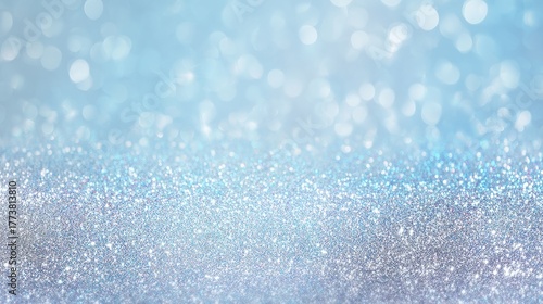 This image features a sparkling blue and silver glitter background with a bokeh effect, creating a vibrant and festive atmosphere perfect for celebrations.