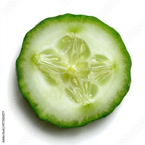 A single cucumber slice, showcasing its vibrant freshness and detailed structure. The close-up view reveals the seed and texture