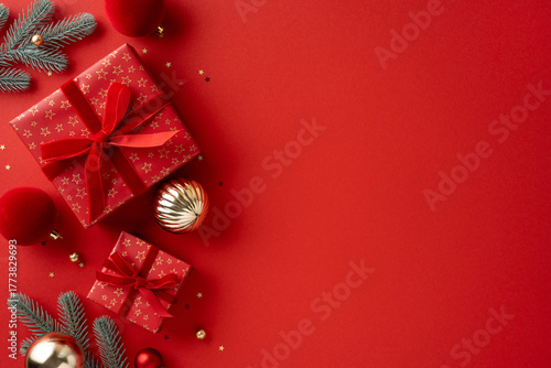 Vibrant Christmas scene with red gifts, gold ornaments, and pine branches on a red backdrop, ideal for holiday greetings and festive celebration themes