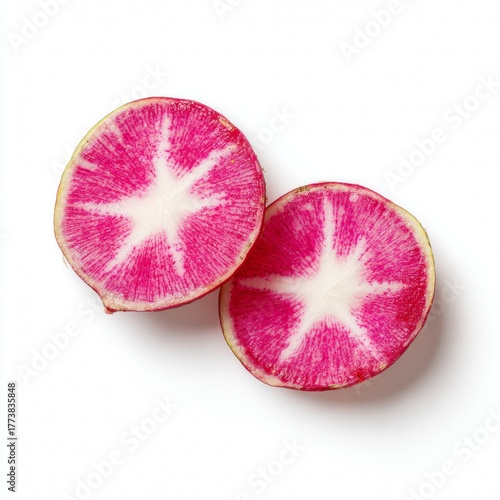 Two halves of a vibrant watermelon radish reveal an intricate star-like pattern