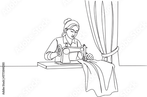 Woman meticulously using sewing machine in a creative and focuse