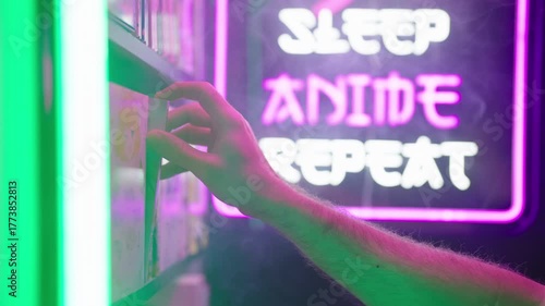 Hand pick a manga comic from shelf with futuristic neon sign in background 4K