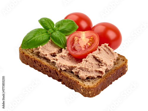 Pâté spread on whole grain bread with cherry tomatoes and fresh basil leaves