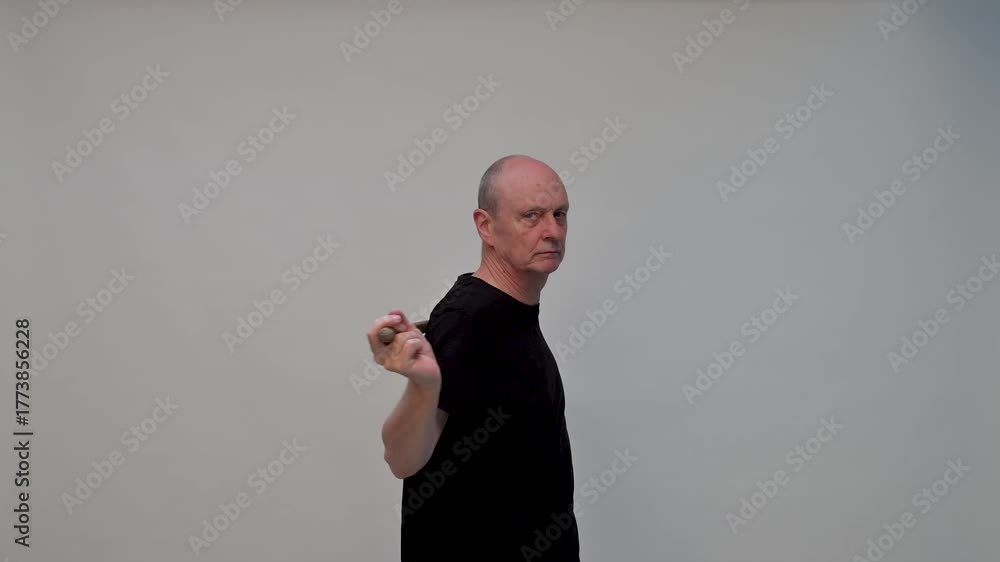 Old man in sportwear practice some exercice with dumbbell