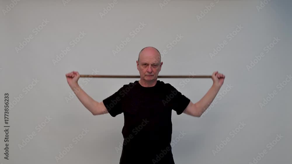 Old man in sportwear practice some exercice with dumbbell
