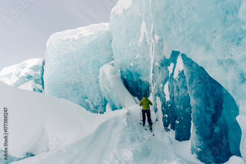 A group of skiers explore the large ice caves in the Northern Rockies of British Columbia, Canada.