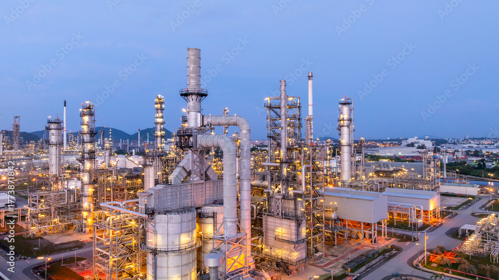 Obraz premium Aerial view oil and gas refinery plant at night, Oil and gas industrial petrochemical fuel power and energy at industry zone, Oil and gas refinery industrial energy supply chain.