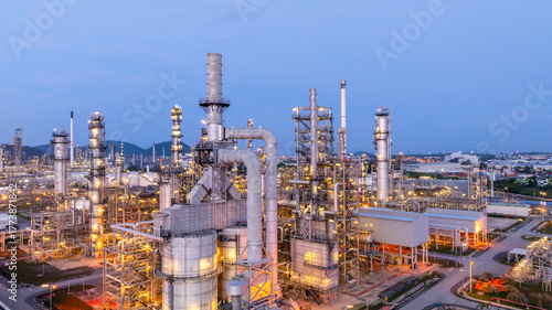 Aerial view oil and gas refinery plant at night, Oil and gas industrial petrochemical fuel power and energy at industry zone, Oil and gas refinery industrial energy supply chain.
