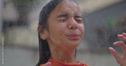 Slika na platnu Young girl rinsing her hair under an outdoor shower on a warm summer day, embrac