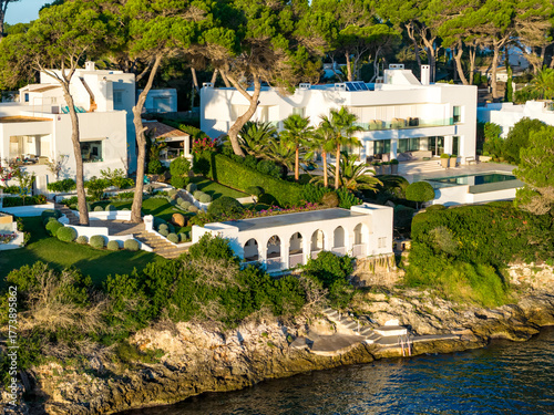 Aerial Sunrise Over Cala d'Or: Multiple Coves, Yachts, and Resort Town on Mallorca's Coast
