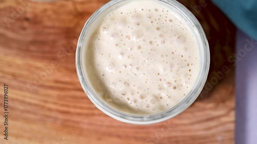 Fresh leaven sourdough starter in glass jars, bright background